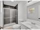 Bathroom featuring a tiled shower, toilet, and single sink vanity at 3035 Linda Dr, Lakeland, FL 33810