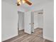 Bedroom featuring wood flooring, a ceiling fan and a closet with mirrored doors at 3035 Linda Dr, Lakeland, FL 33810