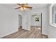 Bedroom featuring wood floors, ceiling fan, and mirrored closet doors at 3035 Linda Dr, Lakeland, FL 33810