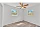 Bedroom with two windows, wood floors, and neutral walls at 3035 Linda Dr, Lakeland, FL 33810