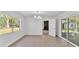 Bright dining room featuring a modern chandelier, tile flooring, and a large window showcasing natural light at 3035 Linda Dr, Lakeland, FL 33810