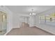 Tile floored dining room featuring an elegant chandelier, offering multiple entries to other areas at 3035 Linda Dr, Lakeland, FL 33810