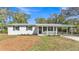 Well-maintained single-story home featuring a covered porch and fresh landscaping enhancing its curb appeal at 3035 Linda Dr, Lakeland, FL 33810