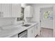 Close-up of a kitchen sink and faucet with white countertops and matching cabinets at 3035 Linda Dr, Lakeland, FL 33810