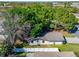 Aerial view of home showing roof, fence, trees, and surrounding neighborhood at 3823 Woodburn E Loop, Lakeland, FL 33813