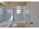 This bathroom features a tub with tile surround and a window for natural light at 3823 Woodburn E Loop, Lakeland, FL 33813