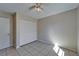 Bedroom featuring a ceiling fan, tiled floors, and a closet with double doors at 3823 Woodburn E Loop, Lakeland, FL 33813