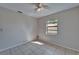 Bedroom with tile flooring and a ceiling fan, ample sunlight through the window at 3823 Woodburn E Loop, Lakeland, FL 33813