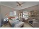 Cozy bedroom featuring a charming bed, desk, and wall decor, creating a delightful retreat for relaxation and study at 3823 Woodburn E Loop, Lakeland, FL 33813