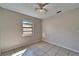 Bedroom with tile floor, ceiling fan, and window providing natural light at 3823 Woodburn E Loop, Lakeland, FL 33813