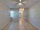 Spacious bedroom featuring tile floors and a ceiling fan, adjacent to the bathroom at 3823 Woodburn E Loop, Lakeland, FL 33813