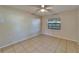 Bedroom with tile flooring, ceiling fan, and natural light from a window at 3823 Woodburn E Loop, Lakeland, FL 33813