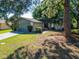 Charming single-story home featuring a well-maintained lawn and an attached two car garage at 3823 Woodburn E Loop, Lakeland, FL 33813