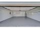 Spacious garage with shelving along walls and ceiling fan at 3823 Woodburn E Loop, Lakeland, FL 33813