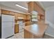 Bright kitchen featuring white appliances, tile flooring, a breakfast bar, and plenty of counter space at 3823 Woodburn E Loop, Lakeland, FL 33813