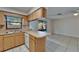 Bright kitchen featuring white appliances, tile flooring, a breakfast bar, and access to outdoor space at 3823 Woodburn E Loop, Lakeland, FL 33813