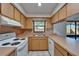 Bright kitchen featuring white appliances, tile flooring, and a breakfast bar with access to outdoor space at 3823 Woodburn E Loop, Lakeland, FL 33813