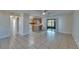 Bright open-concept living space featuring tile floors and sliding glass door leading to the outside at 3823 Woodburn E Loop, Lakeland, FL 33813