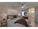 Serene main bedroom showcasing a ceiling fan, comfy king bed, and an ensuite bathroom for ultimate relaxation at 3823 Woodburn E Loop, Lakeland, FL 33813