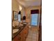 Bathroom featuring a double vanity, tile flooring, and great lighting at 4025 Cheverly E Dr, Lakeland, FL 33813