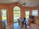 Open dining area features lake view and a breakfast table with wooden chairs and ceramic flooring at 4025 Cheverly E Dr, Lakeland, FL 33813