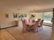 Traditional dining room with a chandelier, light pink chairs and elegant decor at 4025 Cheverly E Dr, Lakeland, FL 33813