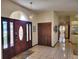 Foyer features tiled flooring, paneled front door, pendant lighting, and closet at 4025 Cheverly E Dr, Lakeland, FL 33813