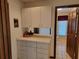 Hallway view with storage cabinets, drawers and view of the bathroom at the end at 4025 Cheverly E Dr, Lakeland, FL 33813