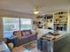 Living room featuring a comfortable sofa, built-in shelves, and plenty of natural light at 4025 Cheverly E Dr, Lakeland, FL 33813