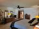 Comfortable main bedroom with neutral tones, ceiling fan, and a view into the main bathroom at 4025 Cheverly E Dr, Lakeland, FL 33813