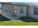 Back patio of house includes door with large arched window at 4025 Cheverly E Dr, Lakeland, FL 33813