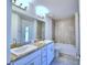 Well-lit bathroom featuring double sinks, granite counters and a tiled shower at 4032 Tullamore Ln, Auburndale, FL 33823