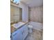 Well-lit bathroom with a single sink, granite counters, and tiled shower at 4032 Tullamore Ln, Auburndale, FL 33823