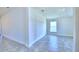 Bright bedroom with neutral paint, tile flooring, and natural light from the window at 4032 Tullamore Ln, Auburndale, FL 33823