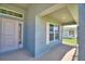 Covered porch featuring the front door, and white picket fence at 4032 Tullamore Ln, Auburndale, FL 33823