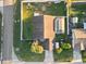 Bird's eye view of a residential home featuring an enclosed pool and manicured lawn in a quiet neighborhood at 404 Emerald Cove Loop, Lakeland, FL 33813