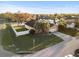 Aerial view of a home with lush landscaping, a two-car garage, and a fenced yard at 404 Emerald Cove Loop, Lakeland, FL 33813