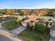 Aerial view of a home with lush landscaping, a two-car garage, and a screened lanai at 404 Emerald Cove Loop, Lakeland, FL 33813