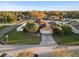 Aerial view of a home with lush landscaping, a two-car garage, and a screened pool at 404 Emerald Cove Loop, Lakeland, FL 33813