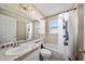 Well-lit bathroom features neutral tile, shower-tub combo, and ample counter space at 404 Emerald Cove Loop, Lakeland, FL 33813