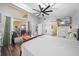 Bright bedroom featuring wood flooring, ensuite bathroom, ceiling fan, and views of the outdoor living area at 404 Emerald Cove Loop, Lakeland, FL 33813