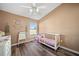 Bright bedroom with wood flooring, ceiling fan, and ample natural light at 404 Emerald Cove Loop, Lakeland, FL 33813