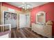 Comfortable bedroom features wood floors, adjacent closet, and decorative furniture at 404 Emerald Cove Loop, Lakeland, FL 33813