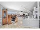 Well-lit kitchen with white cabinets, a built-in desk area, and a seamless transition to the living spaces at 404 Emerald Cove Loop, Lakeland, FL 33813