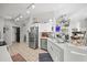 Modern kitchen featuring stainless steel appliances, white countertops, tile flooring, and ample cabinet storage at 404 Emerald Cove Loop, Lakeland, FL 33813