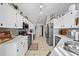 Spacious kitchen with stainless steel appliances, white cabinets, and a view of the adjacent living space at 404 Emerald Cove Loop, Lakeland, FL 33813