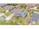 Overhead view of home with a well-maintained lawn, a long driveway and mature landscaping in a residential neighborhood at 4059 The Fenway, Mulberry, FL 33860