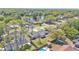 An aerial view of a single Gathering home and neighborhood featuring a community pond at 4059 The Fenway, Mulberry, FL 33860