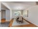 Bright dining room with modern chandelier, wood floors, and neutral decor at 4059 The Fenway, Mulberry, FL 33860