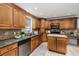 Detailed view of kitchen featuring stainless steel appliances, granite countertops, mosaic backsplash, and a movable island at 4059 The Fenway, Mulberry, FL 33860